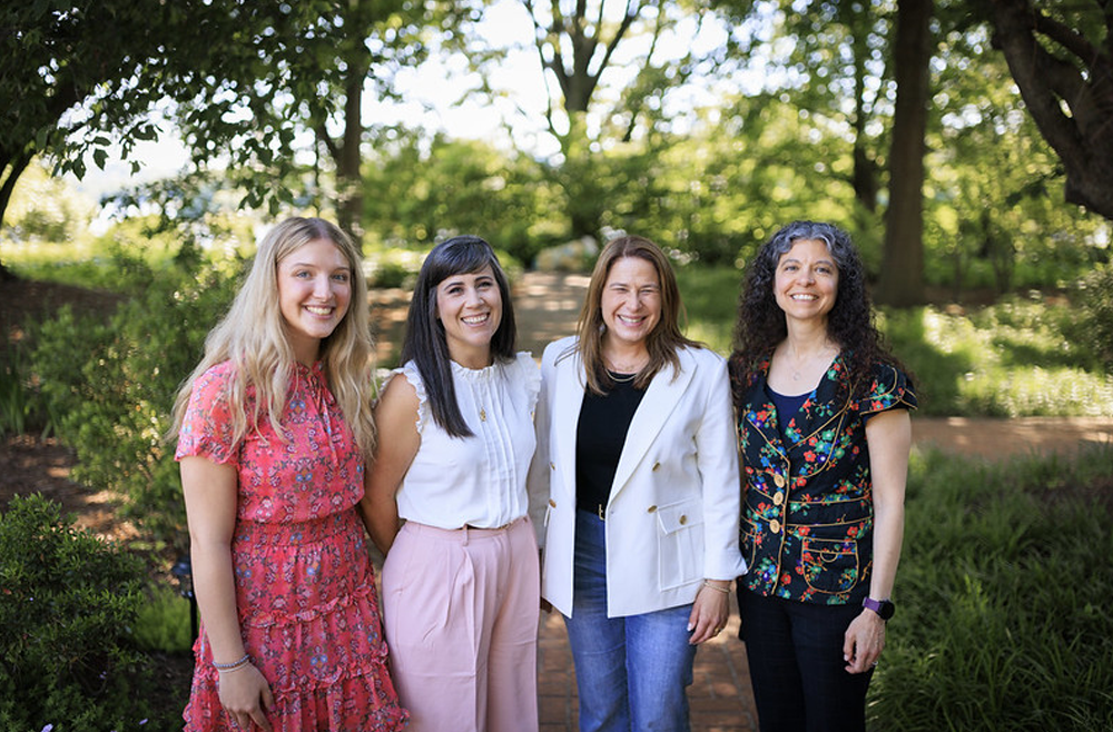 From left to right: Zoe Wiker, Kayla Cook, Lori Shapiro, and Christina Smoker, standing in a wooded area.